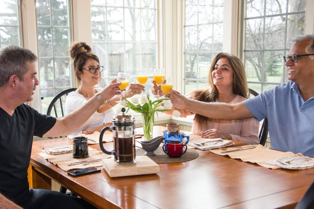 Finger Lakes Bed and Breakfast, two couples sitting around the dining table enjoying a breakfast 