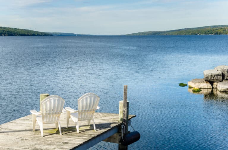 Things to do in the Finger Lakes, photo of a dock with two chairs looking out over the Finger Lakes
