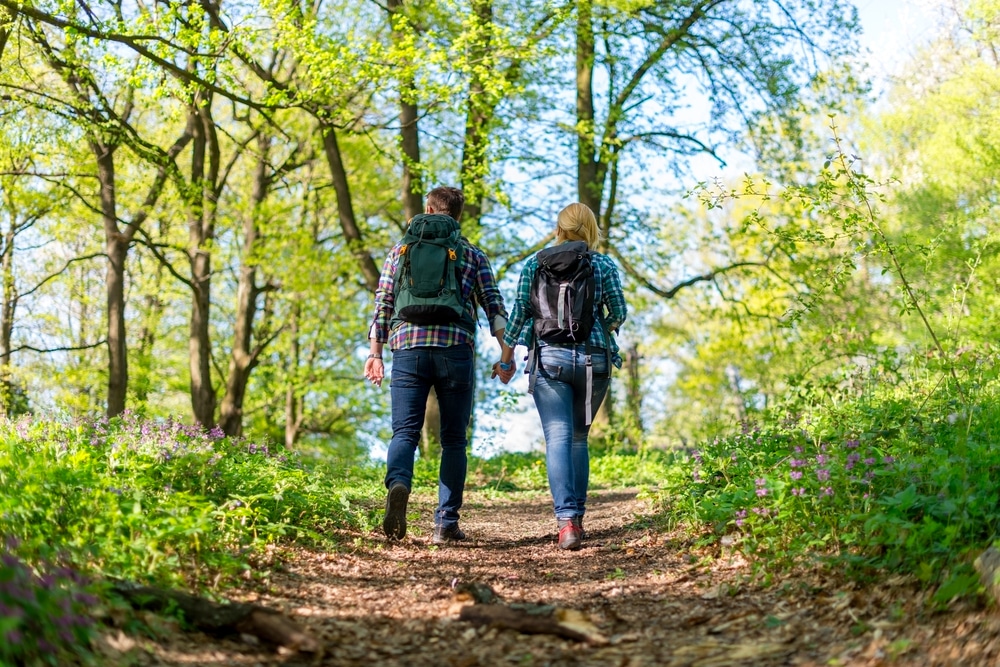 Romantic things to do near our Finger Lakes Bed and Breakfast on a couples retreat, photo of a couple hiking together on a warm day