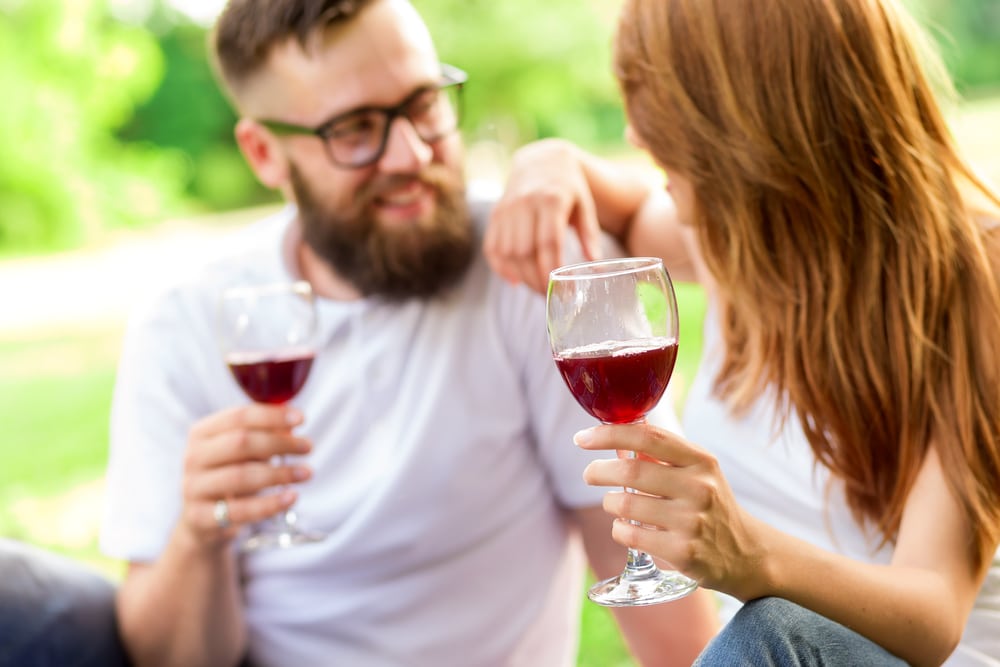 outdoor tastings at the best Finger Lakes Wineries, photo of happy couple enjoying a glass of wine