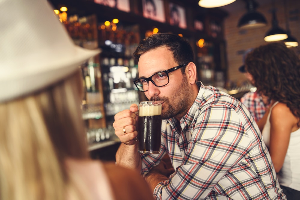 Finger Lakes Breweries, a man enjoy a dark beer in Ithaca