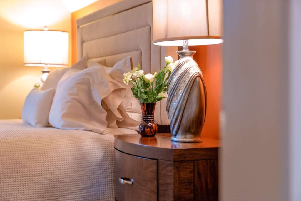 Bed, lamps, flowers in the Syrah Room at our Bed and Breakfast near Ithaca, NY.