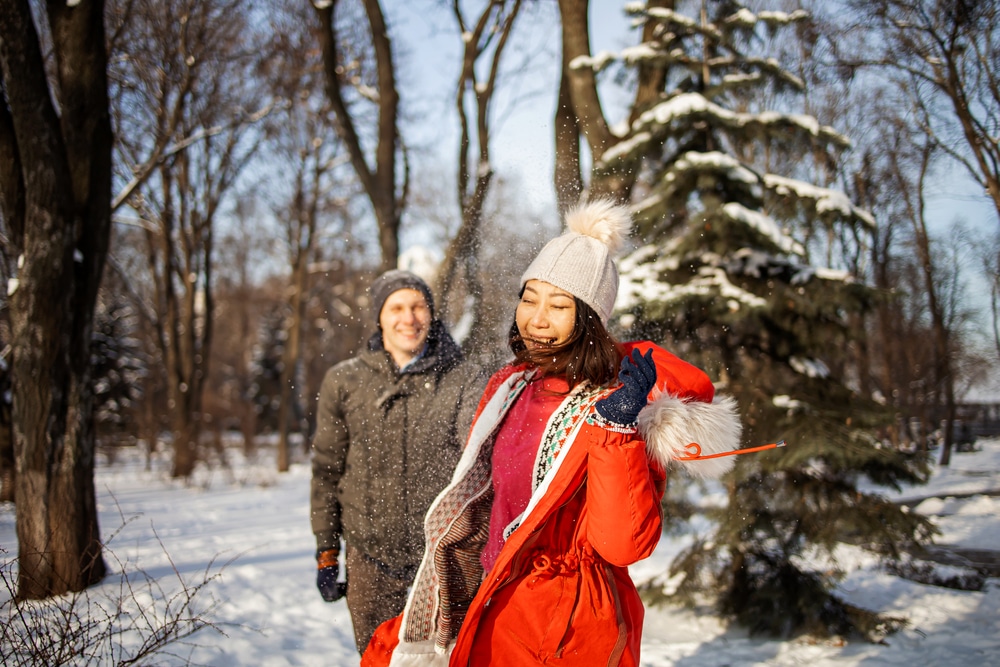 Couple playing in the snow at Finger Lakes National Forest 