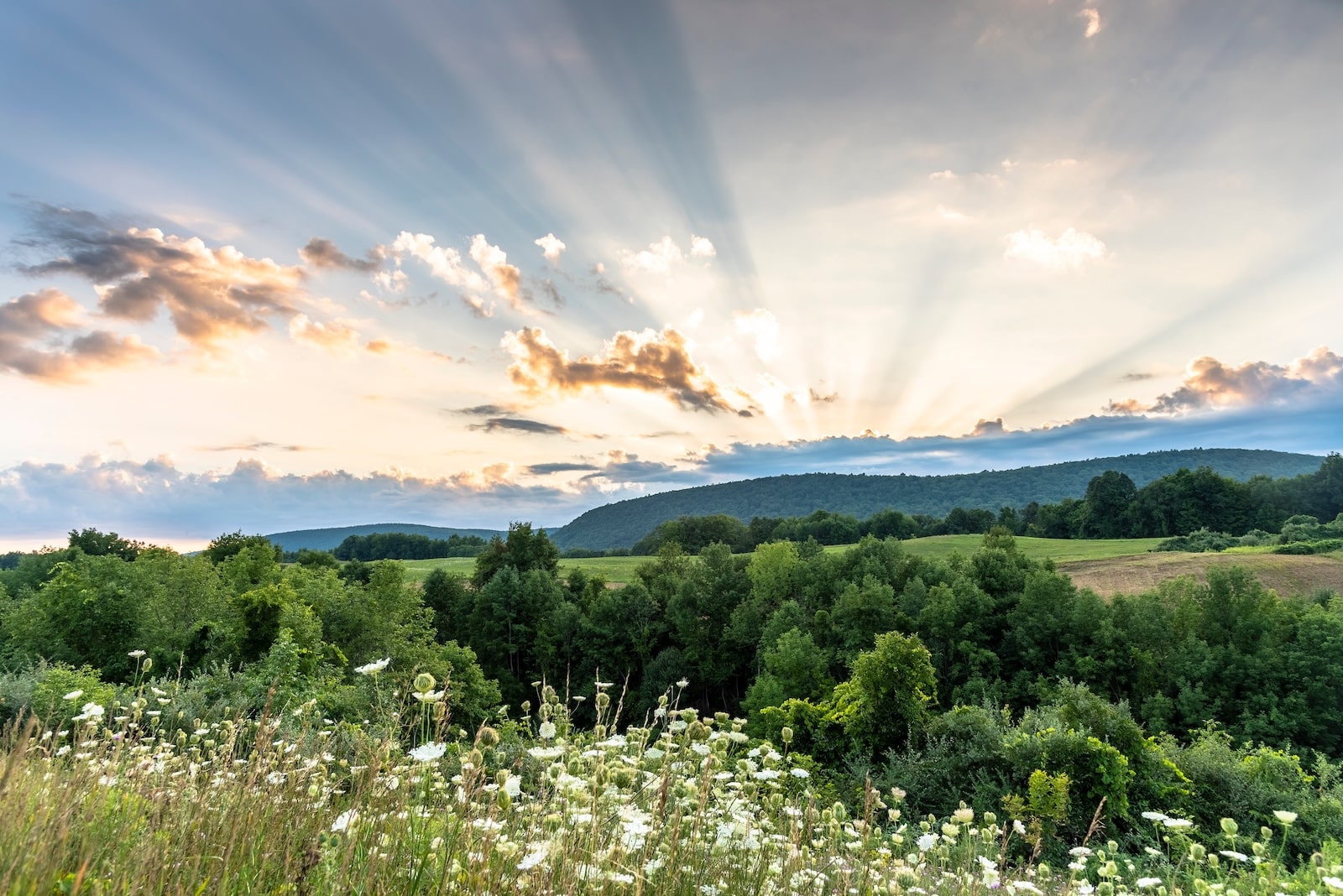 Rolling hills with clouds in the finger lakes of western New York, seeking out these scenic vistas is one of the best things to do in the Finger Lakes NY